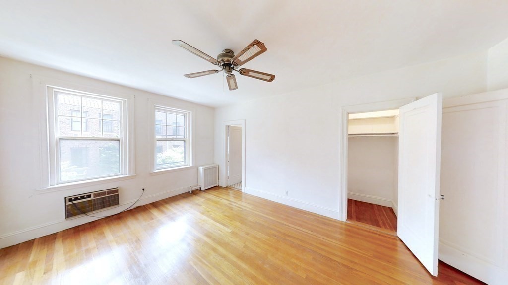 321 Tappan Street, Unit 6 Brookline, MA 02445 - Photo 4 of 14 a view of an empty room with wooden floor and a window