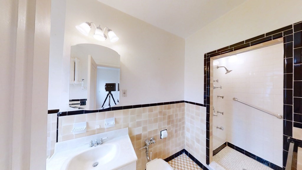 321 Tappan Street, Unit 6 Brookline, MA 02445 - Photo 9 of 14 a bathroom with a mirror sink and vanity