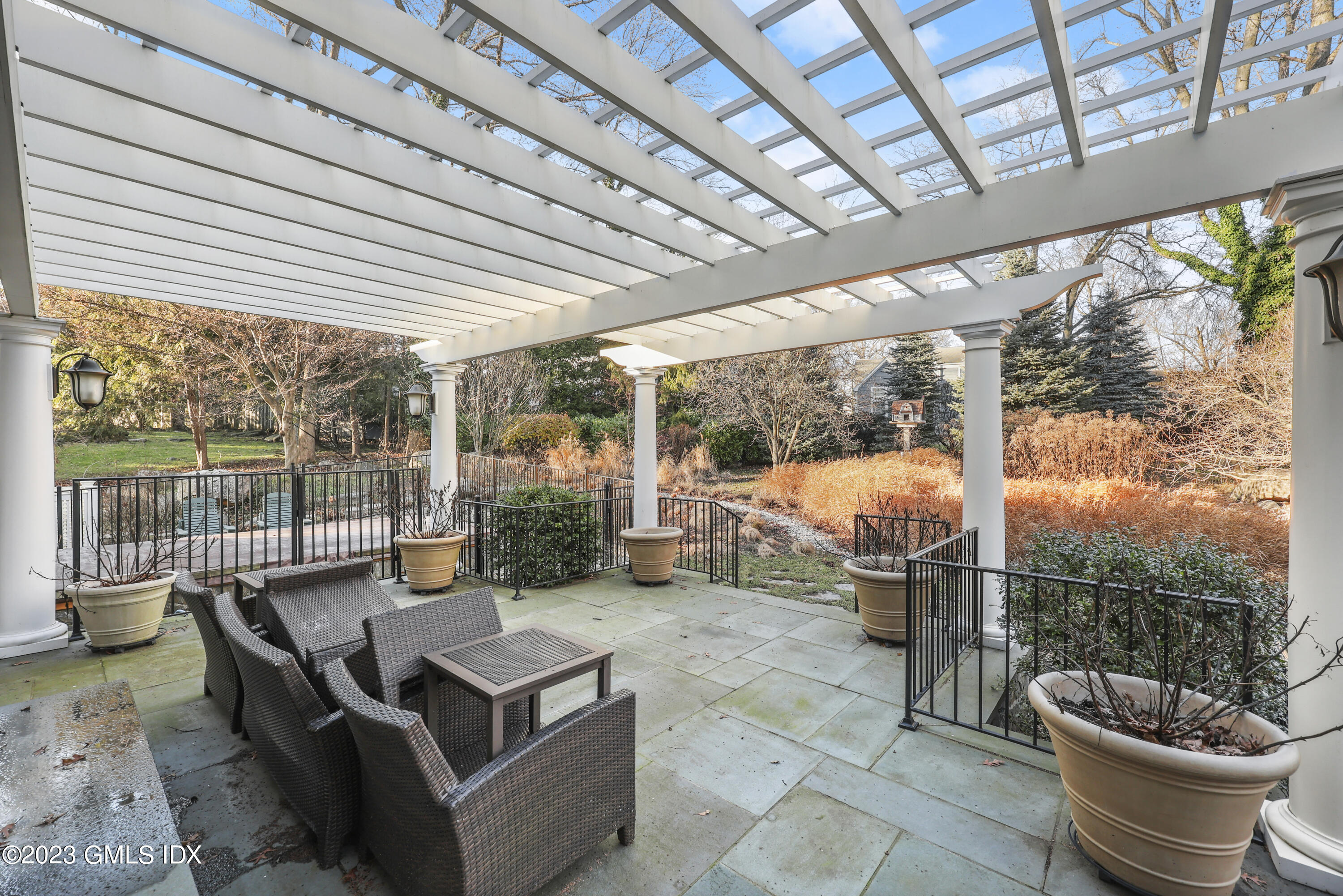 86 Winthrop Drive Riverside, CT 06878 - Photo 22 of 26 a view of a patio with a dining table and chairs