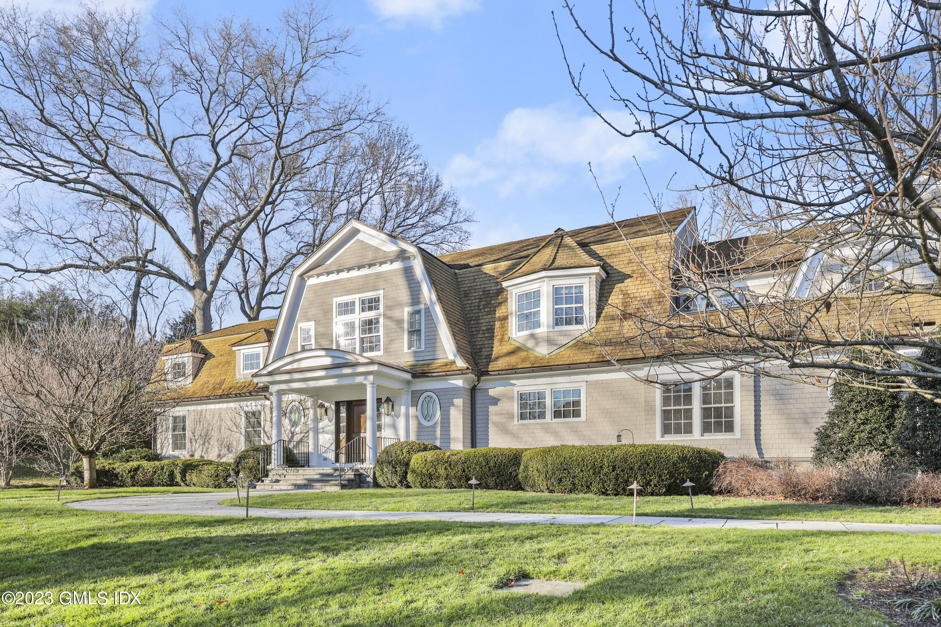 86 Winthrop Drive Riverside, CT 06878 - Photo 24 of 26 a front view of a building with a garden