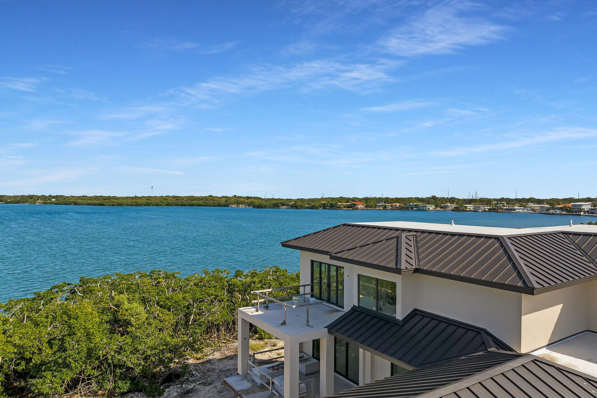 25 Mutiny Place Key Largo, FL 33037 - Photo 34 of 41 a view of a balcony with table and chairs and wooden floor