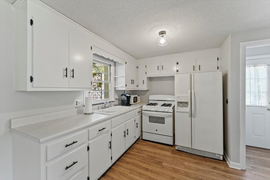 528 Morgan Road West Springfield, MA 01089 - Photo 12 of 42 a kitchen with white cabinets and white appliances