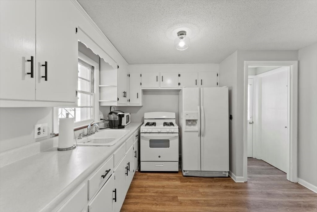 528 Morgan Road West Springfield, MA 01089 - Photo 13 of 42 a kitchen with white cabinets and white appliances