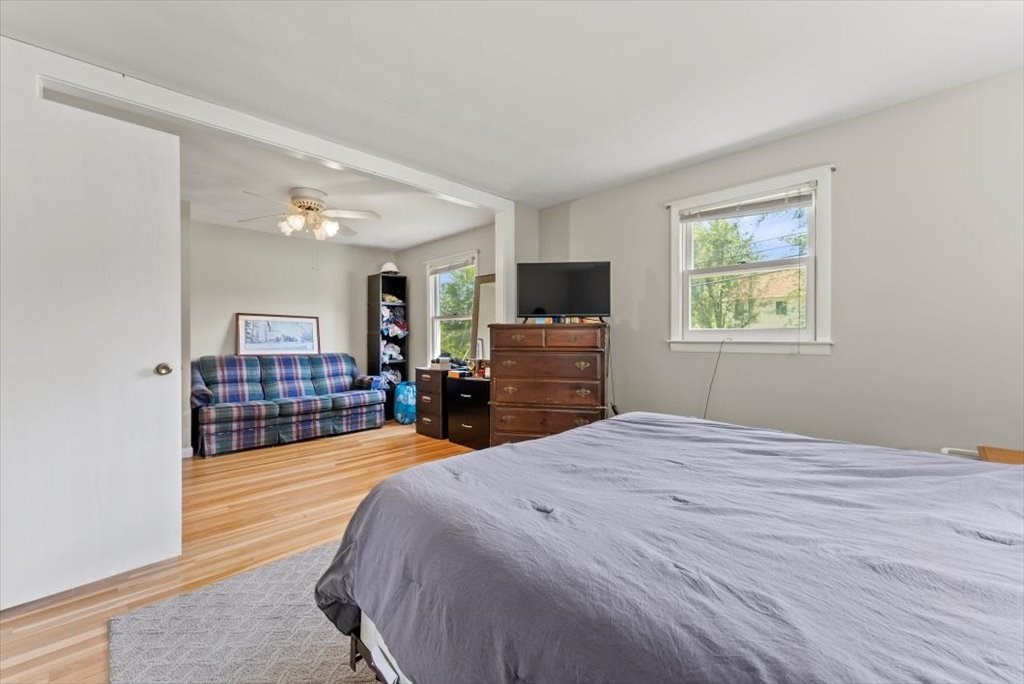 528 Morgan Road West Springfield, MA 01089 - Photo 20 of 42 a large bedroom with wooden floor and a flat screen tv