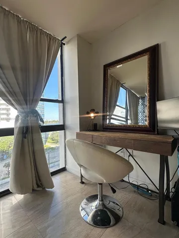 a living room with a couch a rug and a large window