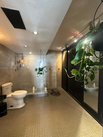 a bathroom with a toilet and a shower