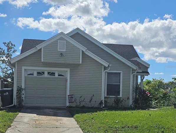 a small barn with a small yard and a large tree