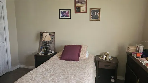 a room with a bed and dresser