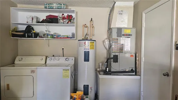 a view of storage and utility room with washer and dryer