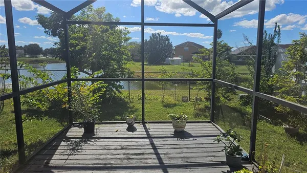 a view of a balcony with floor to ceiling windows with wooden floor
