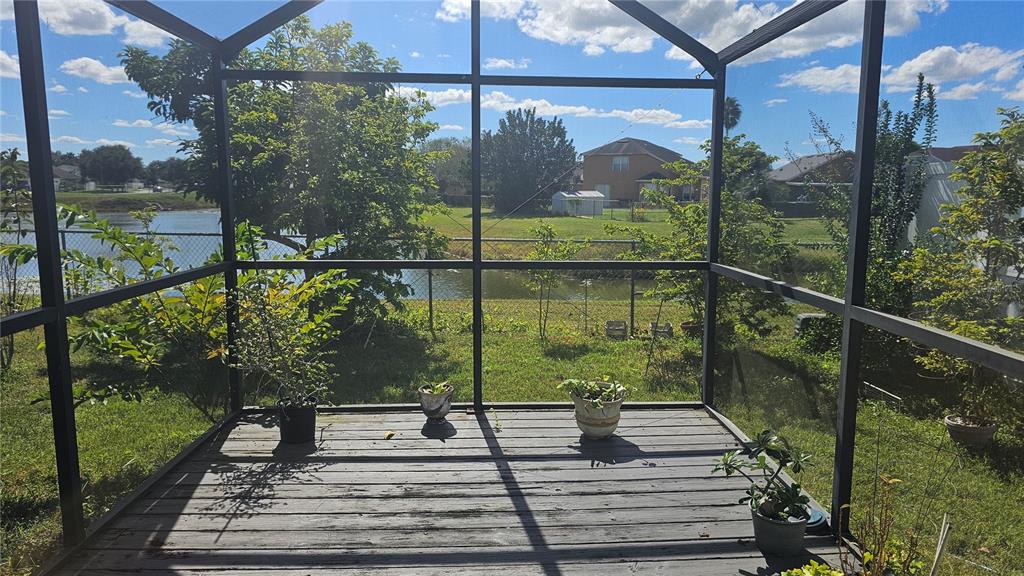 9906 Surrey Ridge Road Orlando, FL 32825 - Photo 16 of 18 a view of a balcony with floor to ceiling windows with wooden floor