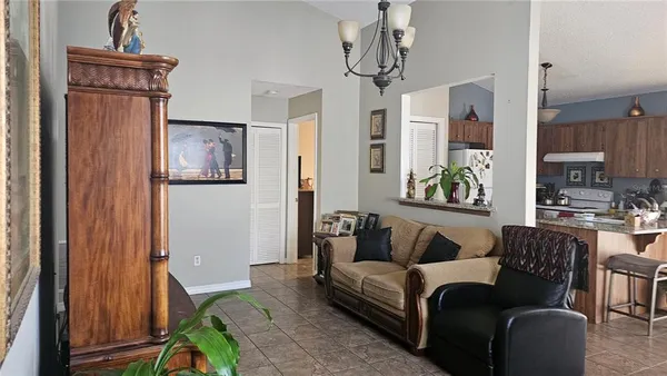 a living room with furniture and a chandelier