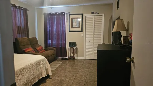 a living room with furniture and a bathroom