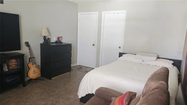 a bedroom with a bed and a tv in it