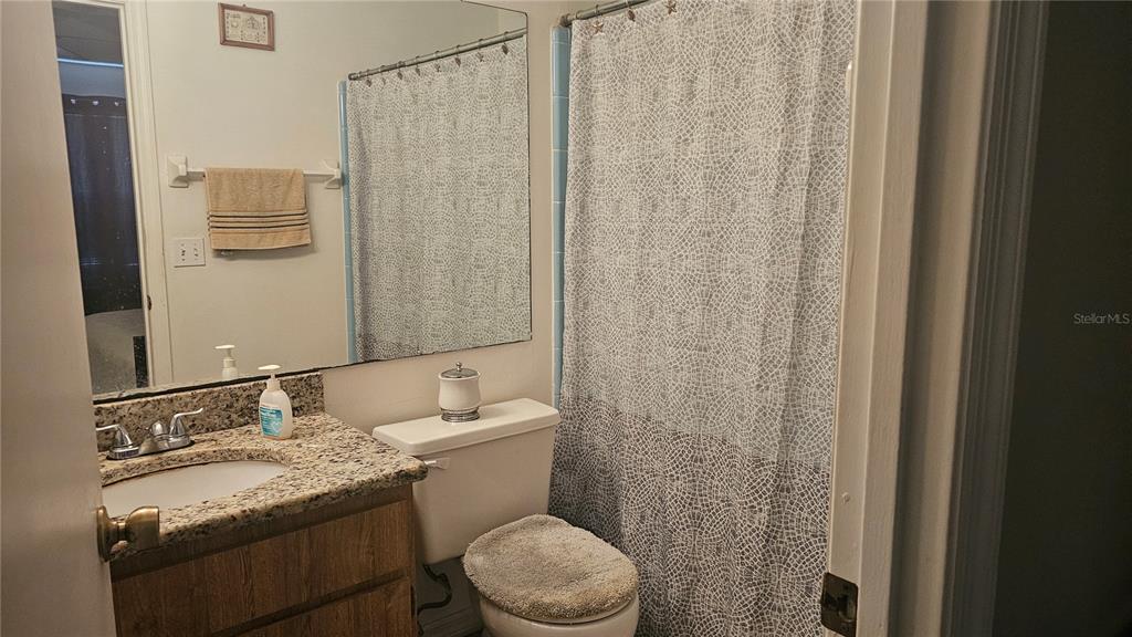 9906 Surrey Ridge Road Orlando, FL 32825 - Photo 10 of 18 a bathroom with a granite countertop sink toilet and shower