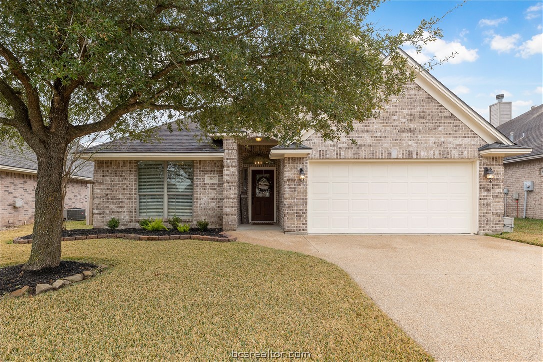 210 Rugen Lane College Station, TX 77845 - Photo 1 of 1 a front view of a house with a yard and garage