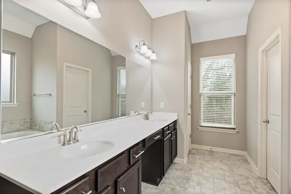 a large bathroom with a large tub shower and sink