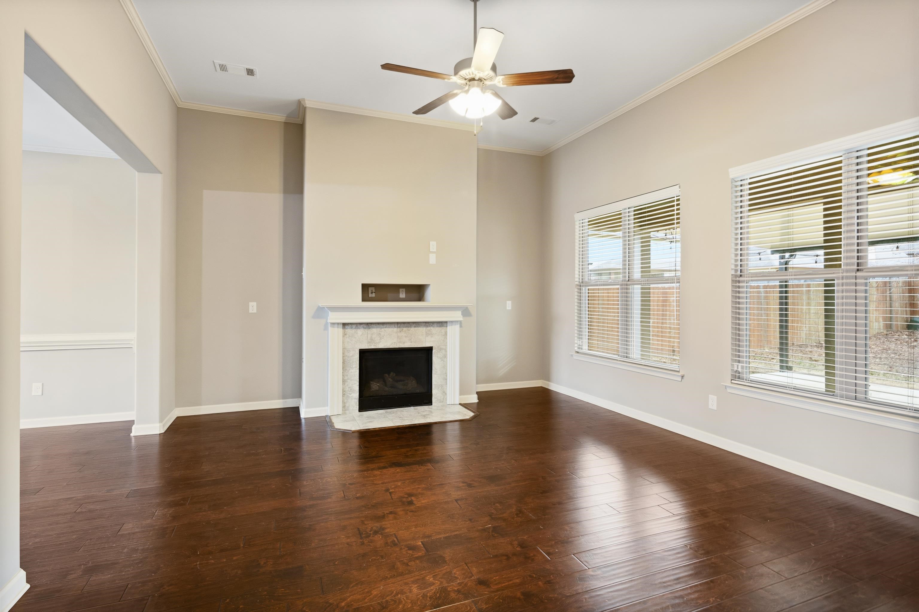 7313 Shadow Run Lane Bartlett, TN 38002 - Photo 11 of 40 a view of empty room with wooden floor and fireplace
