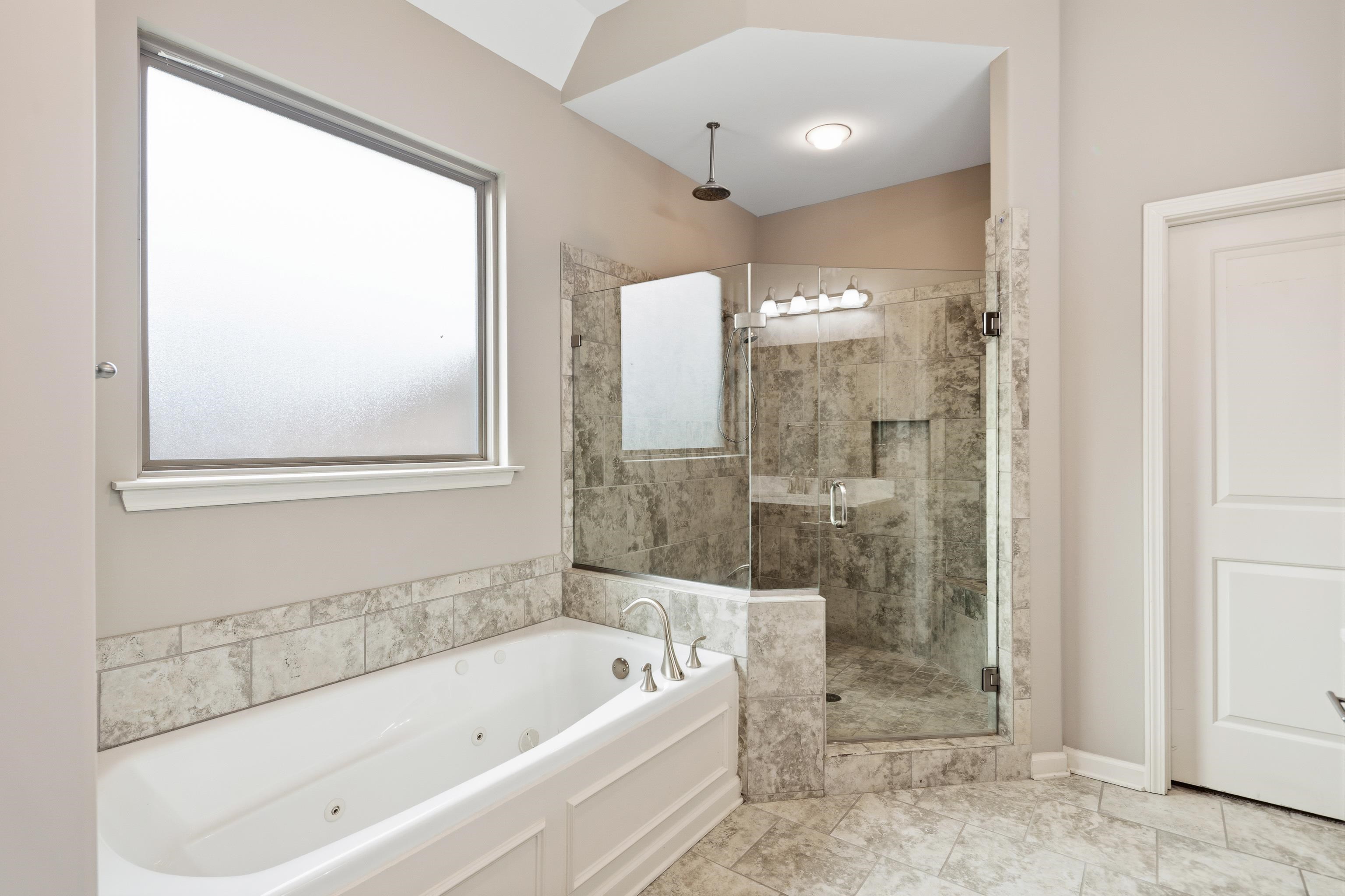 7313 Shadow Run Lane Bartlett, TN 38002 - Photo 27 of 40 a bathroom with a bathtub and a shower