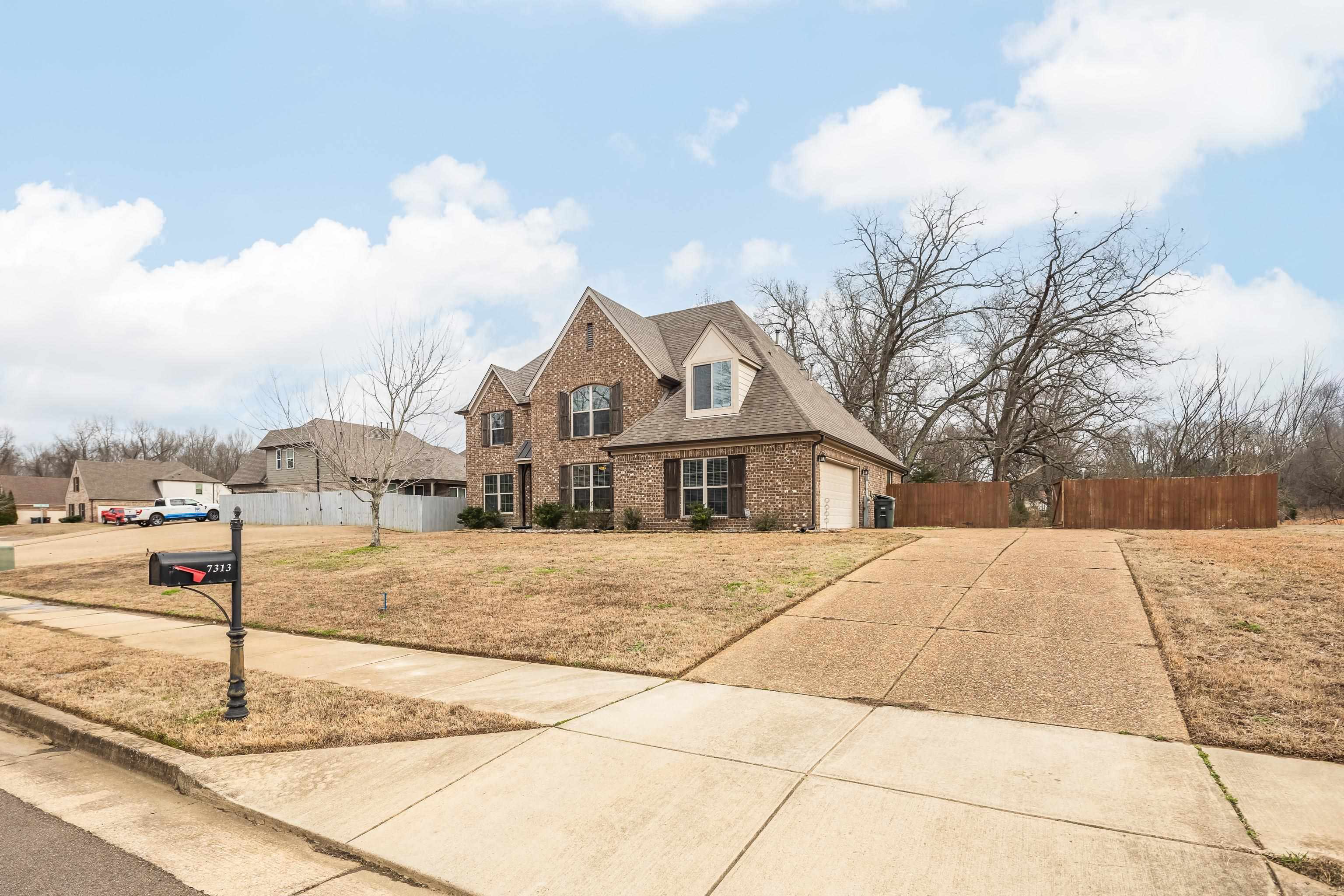 7313 Shadow Run Lane Bartlett, TN 38002 - Photo 3 of 40 a front view of a house with a yard