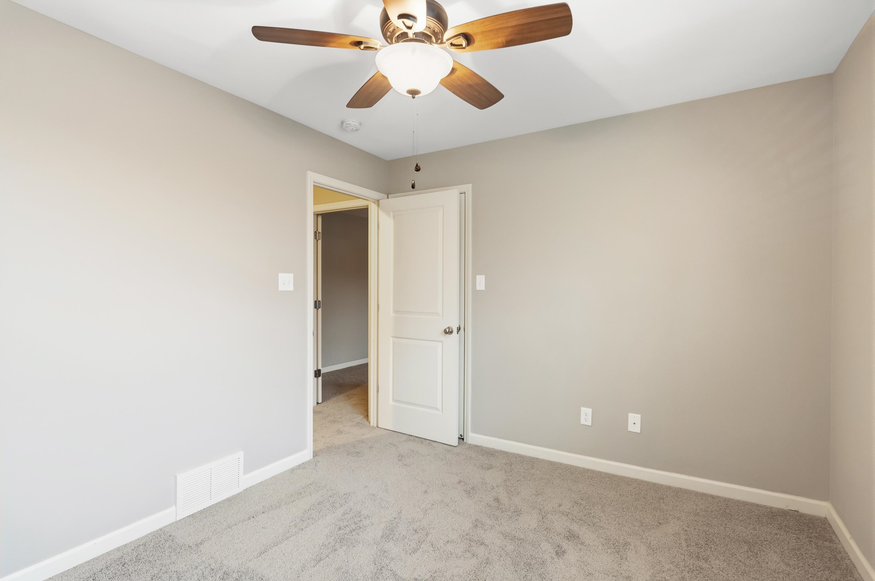 7313 Shadow Run Lane Bartlett, TN 38002 - Photo 39 of 40 an empty room with chandelier fan and a ceiling fan