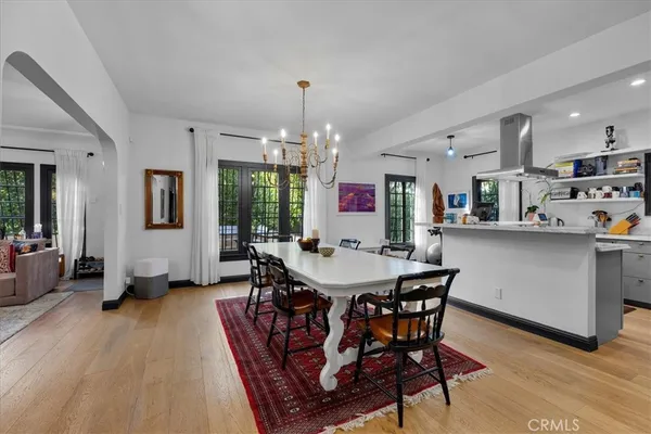 a view of a dining room with furniture and chandelier