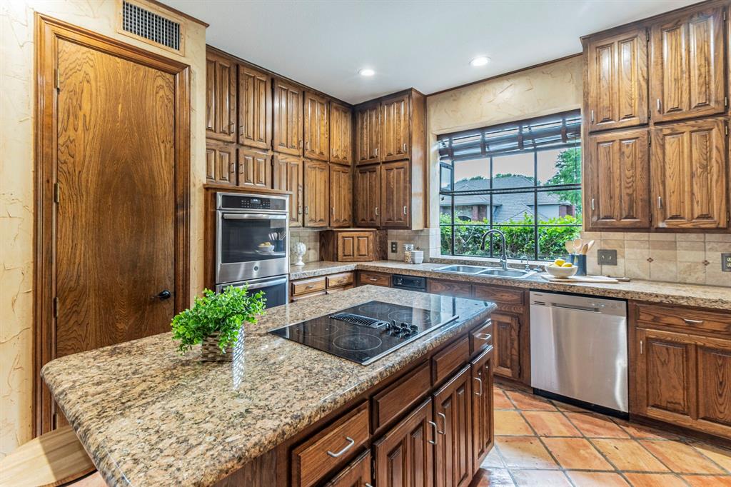 2714 Ridge Top Lane Arlington, TX 76006 - Photo 10 of 37 Kitchen with a kitchen island, light stone countertops, stainless steel appliances, backsplash, and recessed lighting