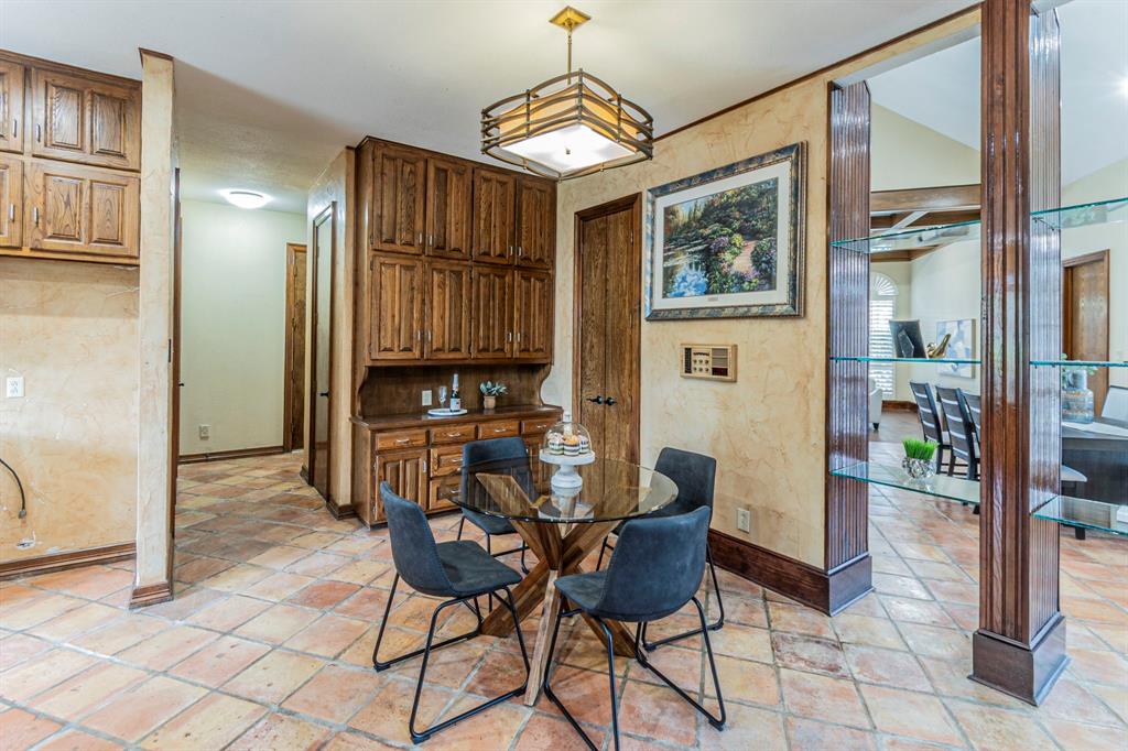 2714 Ridge Top Lane Arlington, TX 76006 - Photo 12 of 37 Dining space featuring baseboards and lofted ceiling