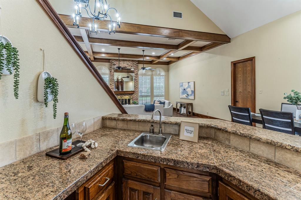 2714 Ridge Top Lane Arlington, TX 76006 - Photo 37 of 37 Kitchen with a ceiling fan, open floor plan, hanging lights, and coffered ceiling