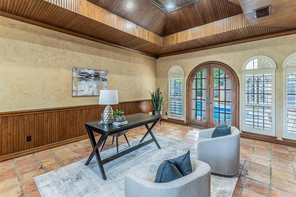2714 Ridge Top Lane Arlington, TX 76006 - Photo 15 of 37 Office area with french doors, a wainscoted wall, wood walls, and stone tile floors