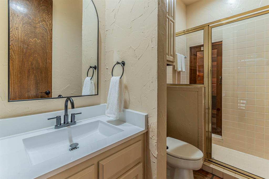 2714 Ridge Top Lane Arlington, TX 76006 - Photo 16 of 37 Bathroom with a textured wall, vanity, and a stall shower