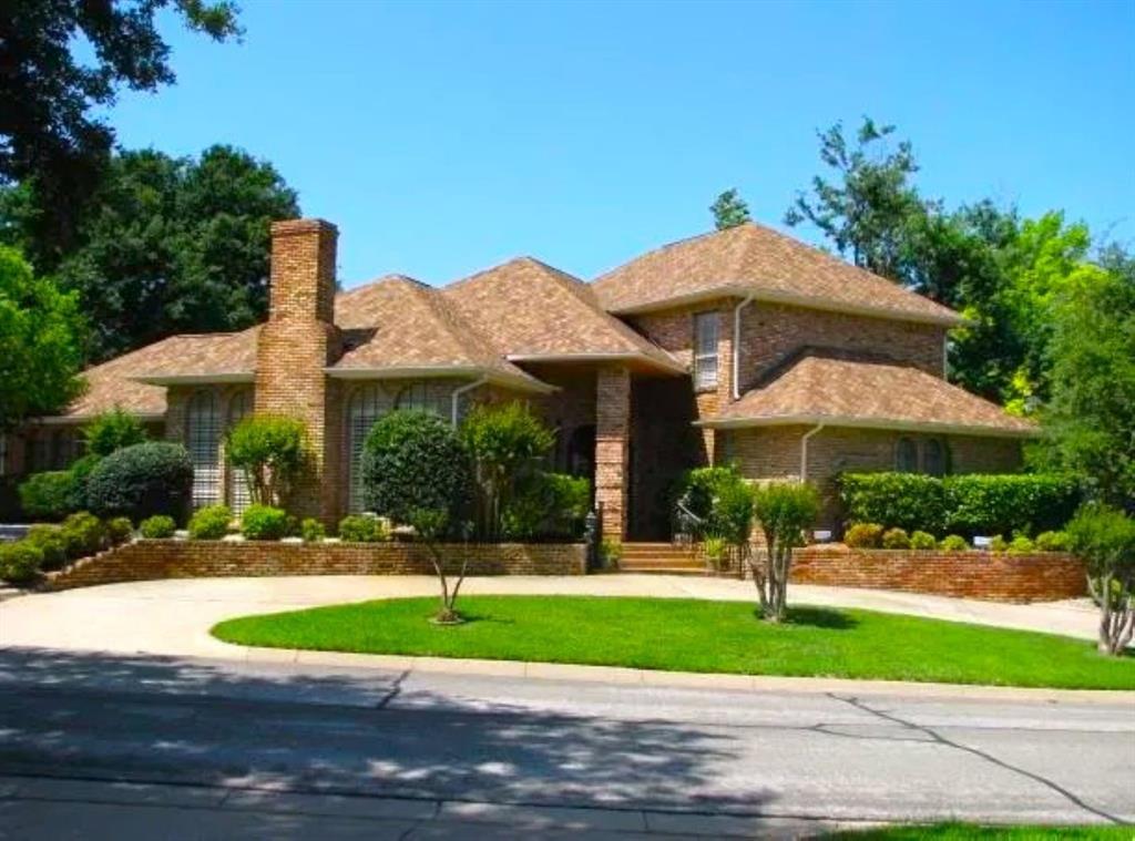2714 Ridge Top Lane Arlington, TX 76006 - Photo 2 of 37 View of front of home featuring brick siding, a front yard, a chimney, and curved driveway