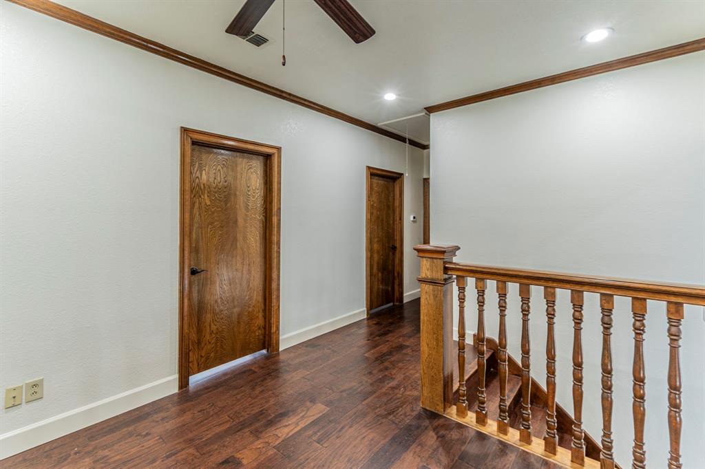 2714 Ridge Top Lane Arlington, TX 76006 - Photo 24 of 37 Corridor with crown molding, dark wood-type flooring, recessed lighting, and an upstairs landing
