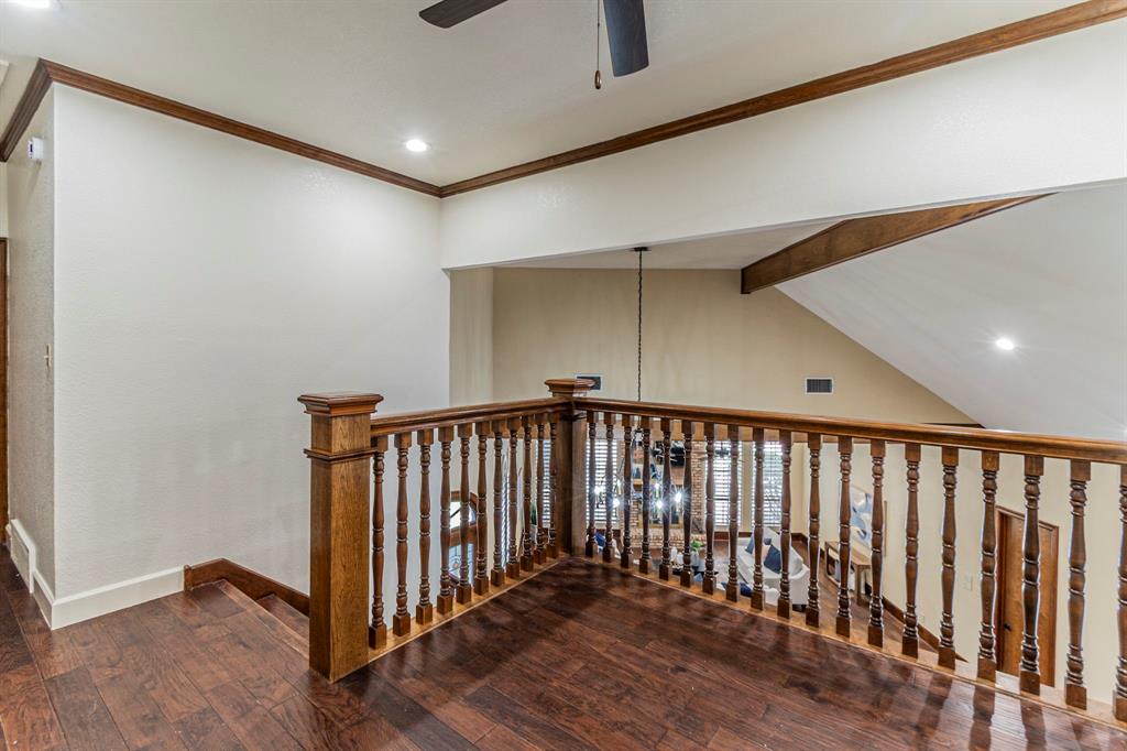 2714 Ridge Top Lane Arlington, TX 76006 - Photo 25 of 37 Hallway with recessed lighting, dark wood-style floors, ornamental molding, and lofted ceiling