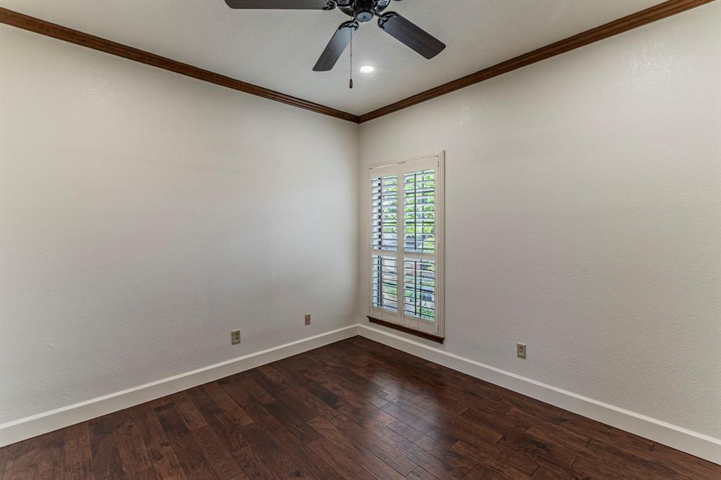 2714 Ridge Top Lane Arlington, TX 76006 - Photo 26 of 37 Spare room with dark wood-type flooring, a ceiling fan, and ornamental molding