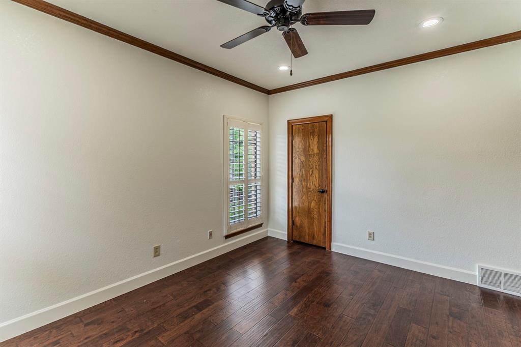 2714 Ridge Top Lane Arlington, TX 76006 - Photo 29 of 37 Empty room featuring crown molding, dark wood-type flooring, ceiling fan, recessed lighting, and a textured wall