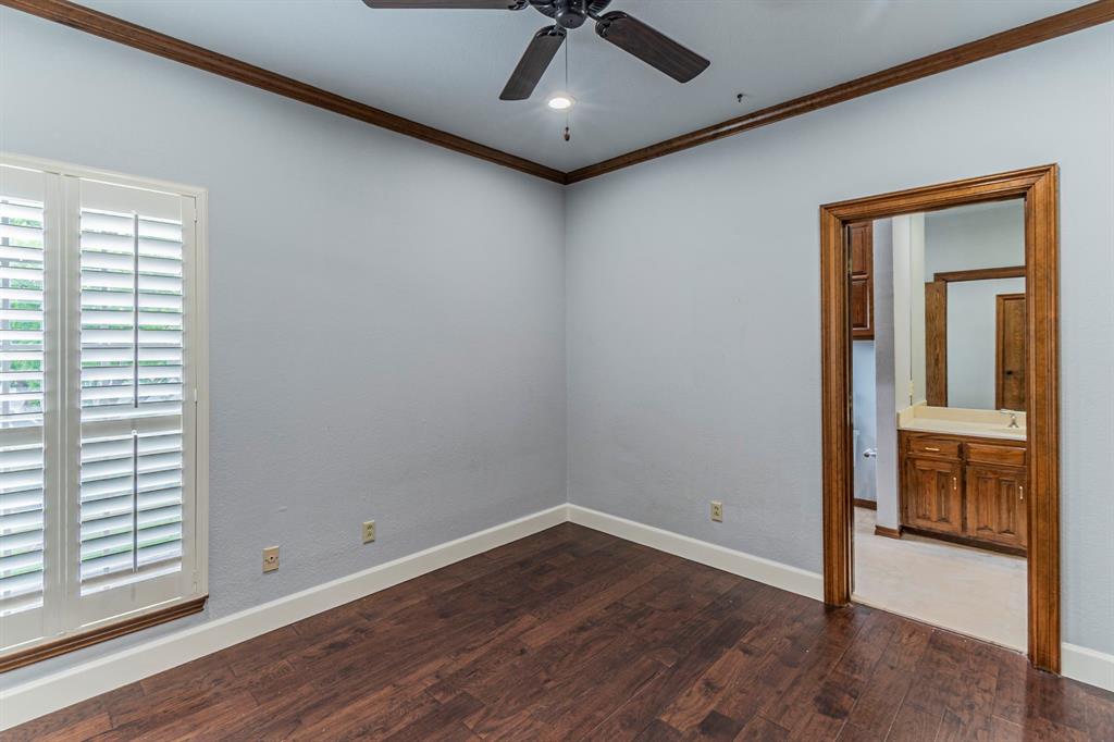 2714 Ridge Top Lane Arlington, TX 76006 - Photo 31 of 37 Unfurnished bedroom featuring dark wood-style flooring, a ceiling fan, ornamental molding, and ensuite bath