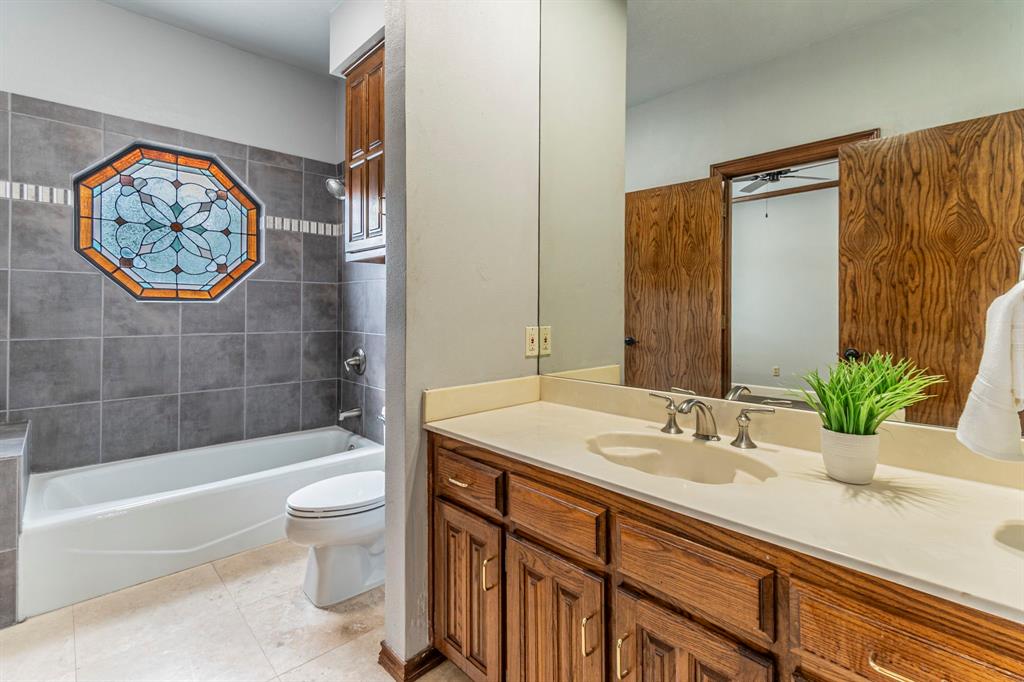 2714 Ridge Top Lane Arlington, TX 76006 - Photo 33 of 37 Full bathroom with vanity, shower combination, and light tile patterned flooring