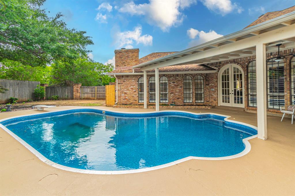 2714 Ridge Top Lane Arlington, TX 76006 - Photo 35 of 37 View of swimming pool with a fenced backyard, patio surround, french doors, and a diving board