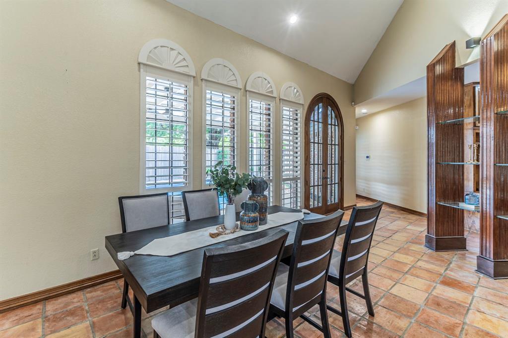 2714 Ridge Top Lane Arlington, TX 76006 - Photo 7 of 37 Dining room with recessed lighting, stone tile flooring, vaulted ceiling, and french doors