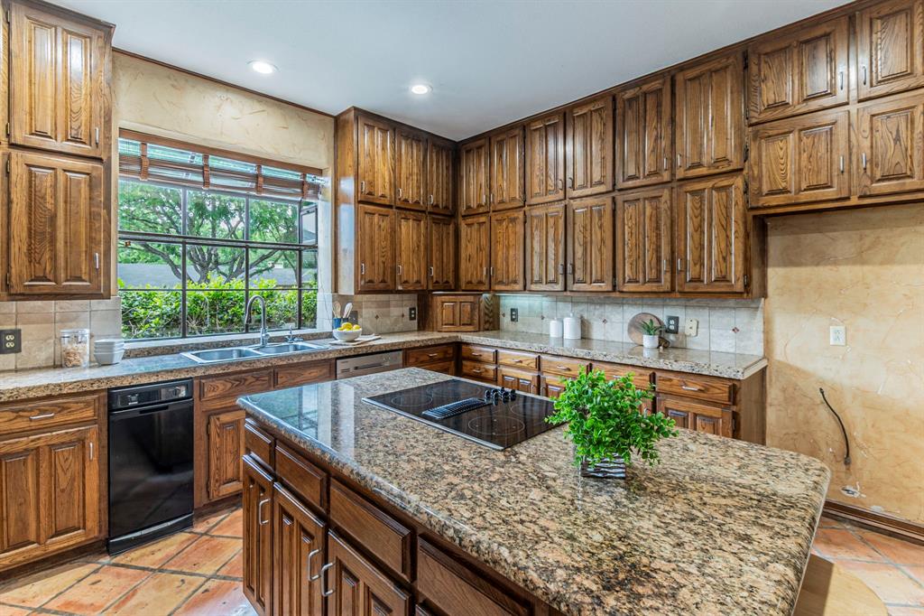 2714 Ridge Top Lane Arlington, TX 76006 - Photo 9 of 37 Kitchen featuring decorative backsplash, a center island, black electric stovetop, dark stone countertops, and recessed lighting