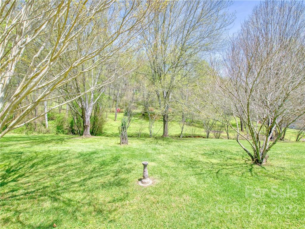322 Kitchens Branch Road Sylva, NC 28779 - Photo 8 of 48 a backyard of apartments with large trees