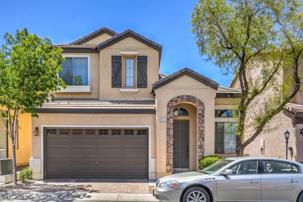 8121 Altamont Ridge Street Las Vegas, NV 89113 - Photo 1 of 27 View of front facade featuring a tile roof, drivew
