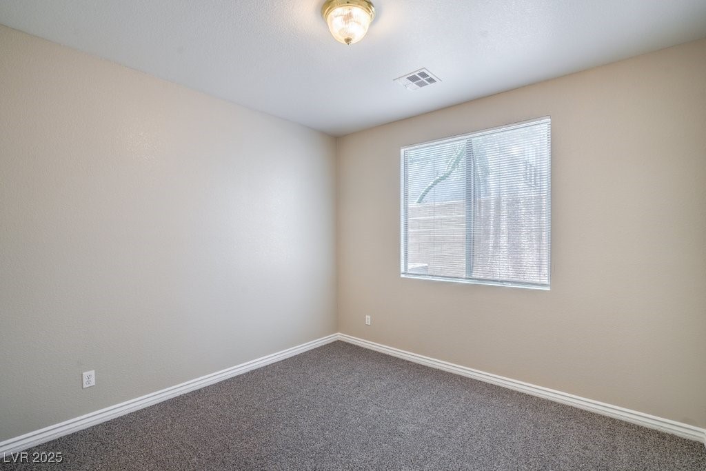 8121 Altamont Ridge Street Las Vegas, NV 89113 - Photo 16 of 27 Primary downstairs bedroom featuring new carpet &