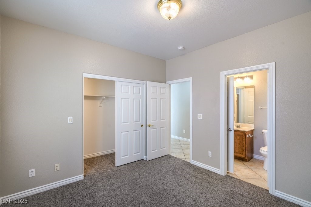8121 Altamont Ridge Street Las Vegas, NV 89113 - Photo 17 of 27 Primary bedroom downstairs featuring carpet floor