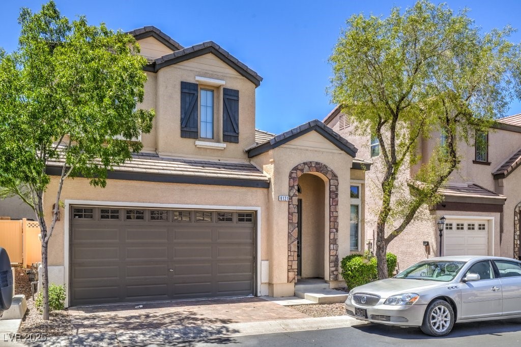 8121 Altamont Ridge Street Las Vegas, NV 89113 - Photo 2 of 27 Traditional home with a tile roof, stucco siding,