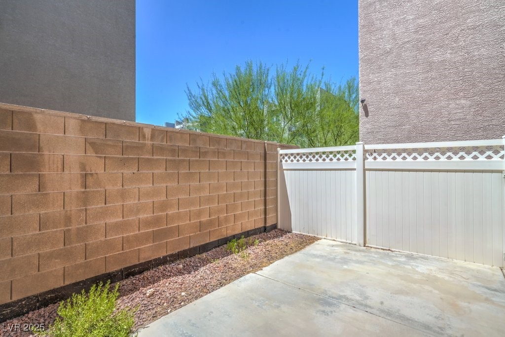 8121 Altamont Ridge Street Las Vegas, NV 89113 - Photo 22 of 27 Fenced backyard with a patio area ready for your v