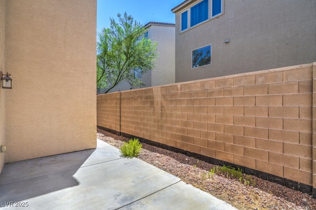 8121 Altamont Ridge Street Las Vegas, NV 89113 - Photo 23 of 27 View of side of property featuring stucco siding a