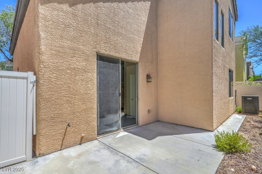 8121 Altamont Ridge Street Las Vegas, NV 89113 - Photo 24 of 27 Rear view of house featuring stucco siding and a p