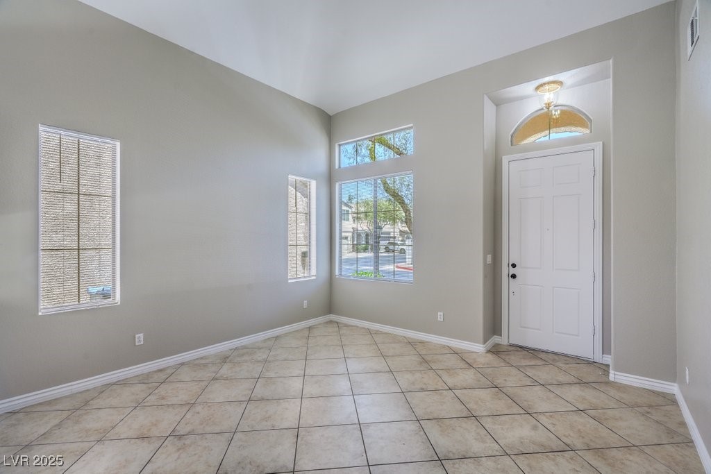 8121 Altamont Ridge Street Las Vegas, NV 89113 - Photo 5 of 27 Foyer entrance featuring baseboards and light tile